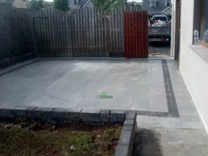 Granite Slabbed Patio with Charcoal Borderline and Connemara Walling in Killinierin, Co. Wexford