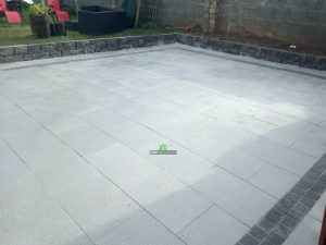 Granite Slabbed Patio with Charcoal Borderline and Connemara Walling in Killinierin, Co. Wexford