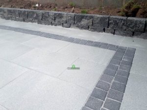 Granite Slabbed Patio with Charcoal Borderline and Connemara Walling in Killinierin, Co. Wexford